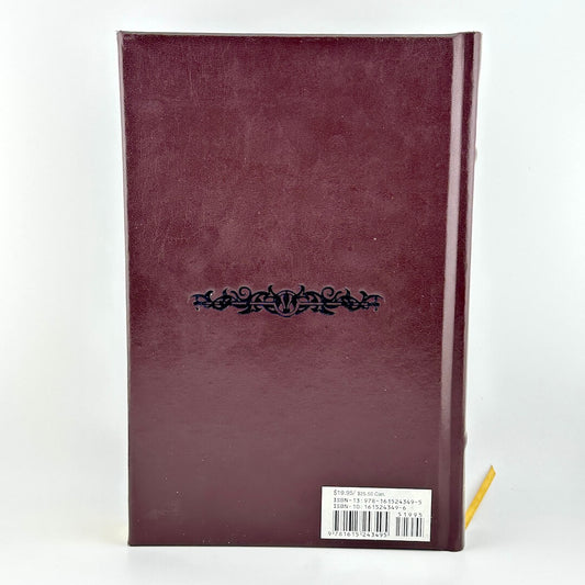 Maroon notebook with decorative element on a white background