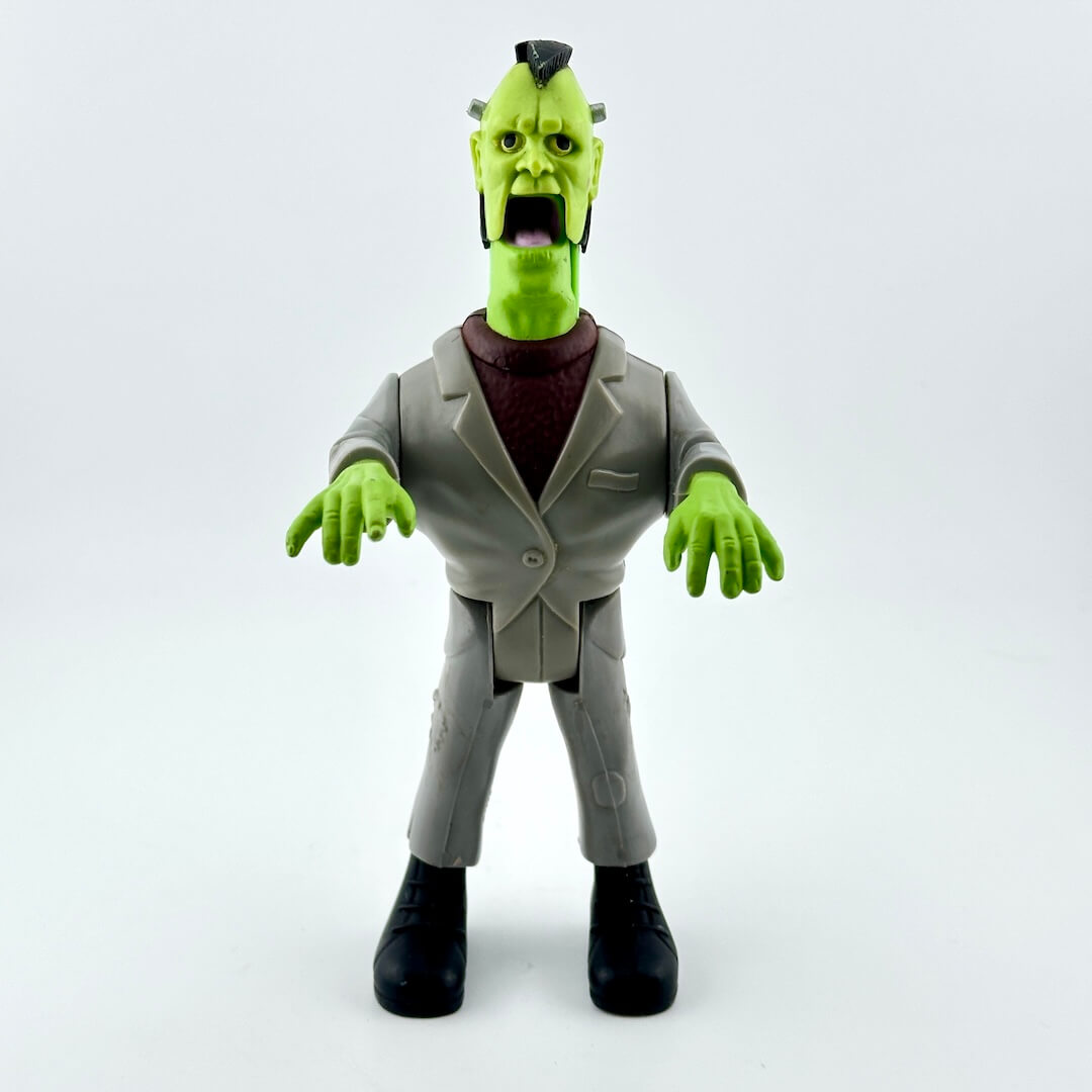 Toy figure of a green monster in a suit on a white background