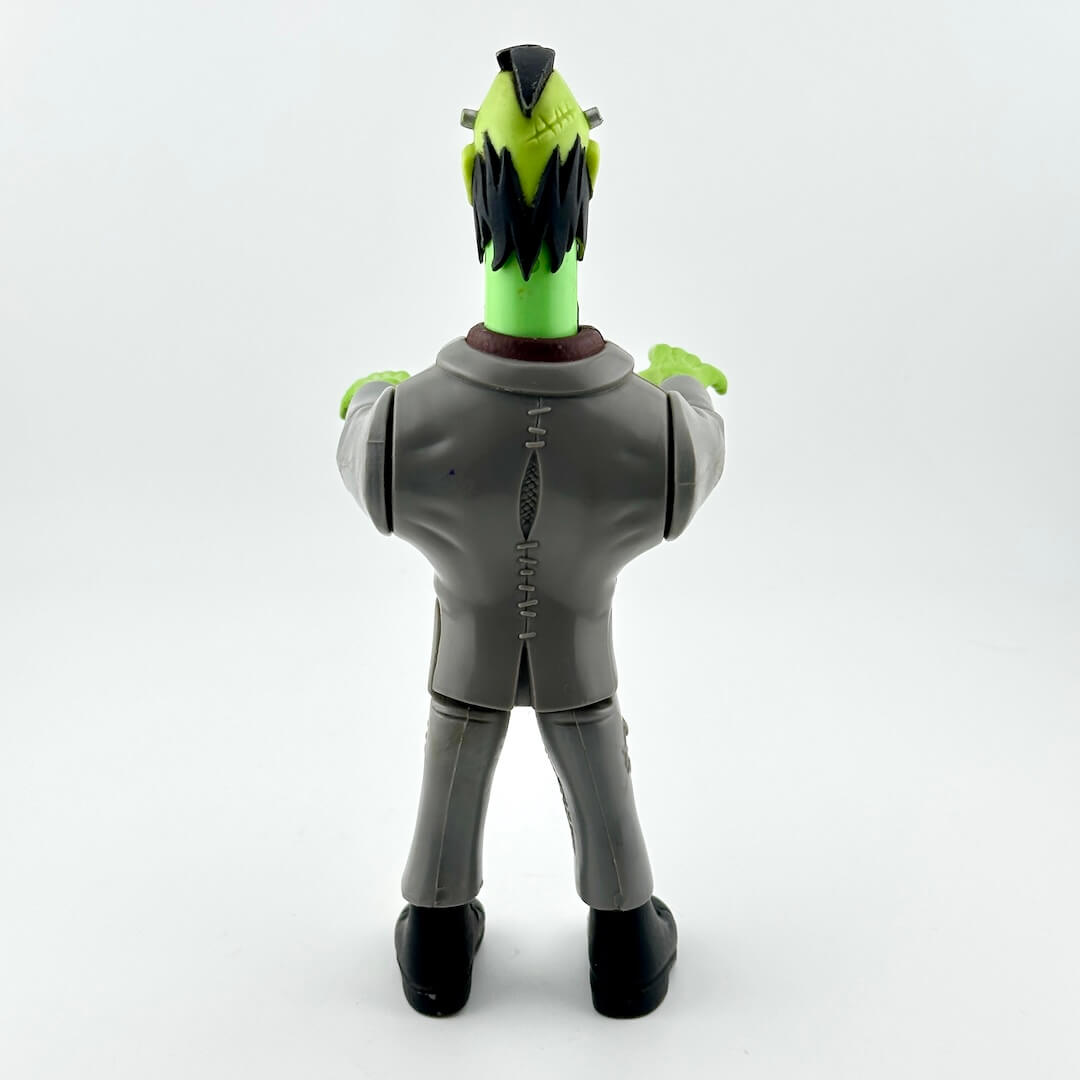 Toy figure with green head and gray suit on a white background