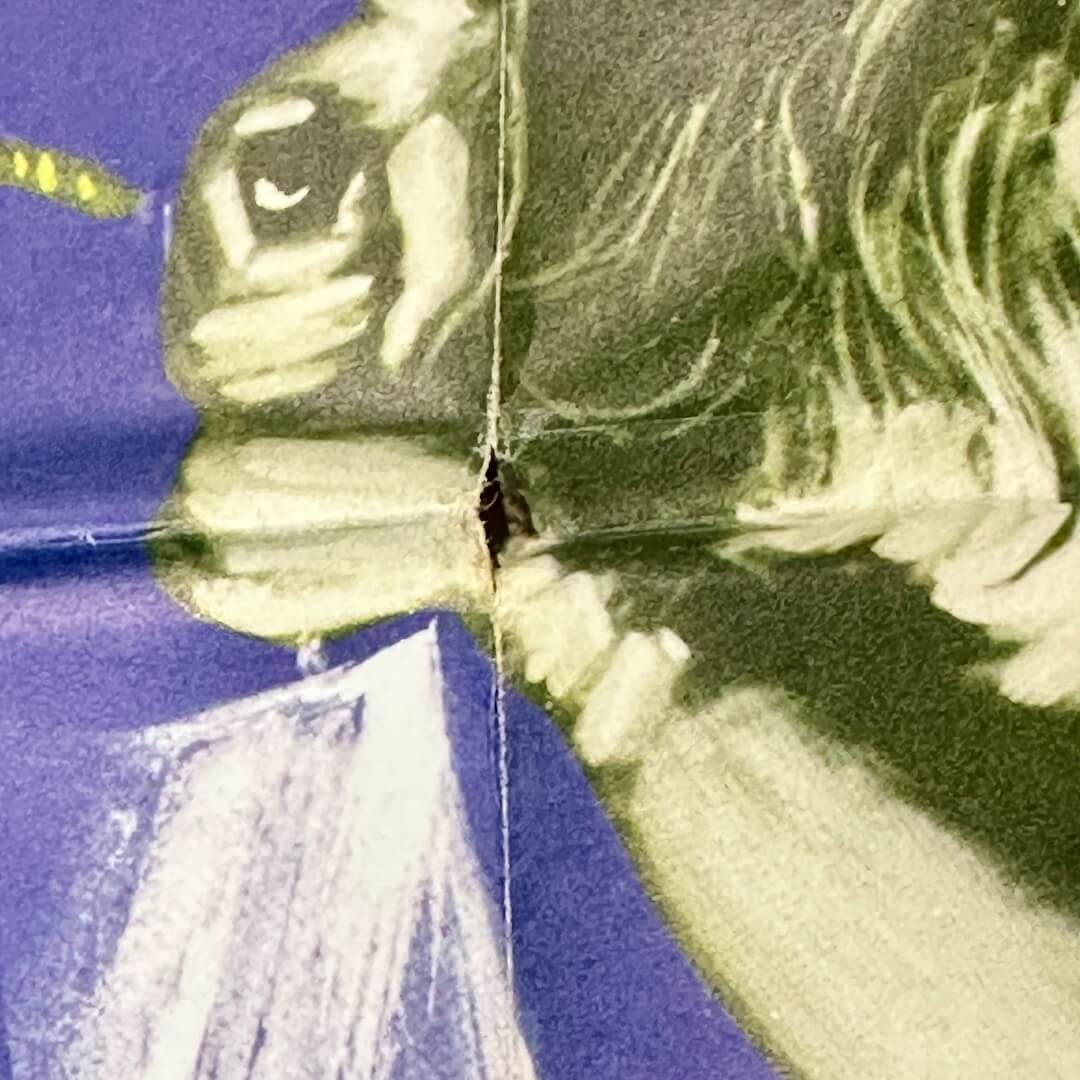 Close up of hole in poster