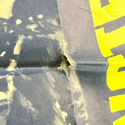 Close up of hole in poster
