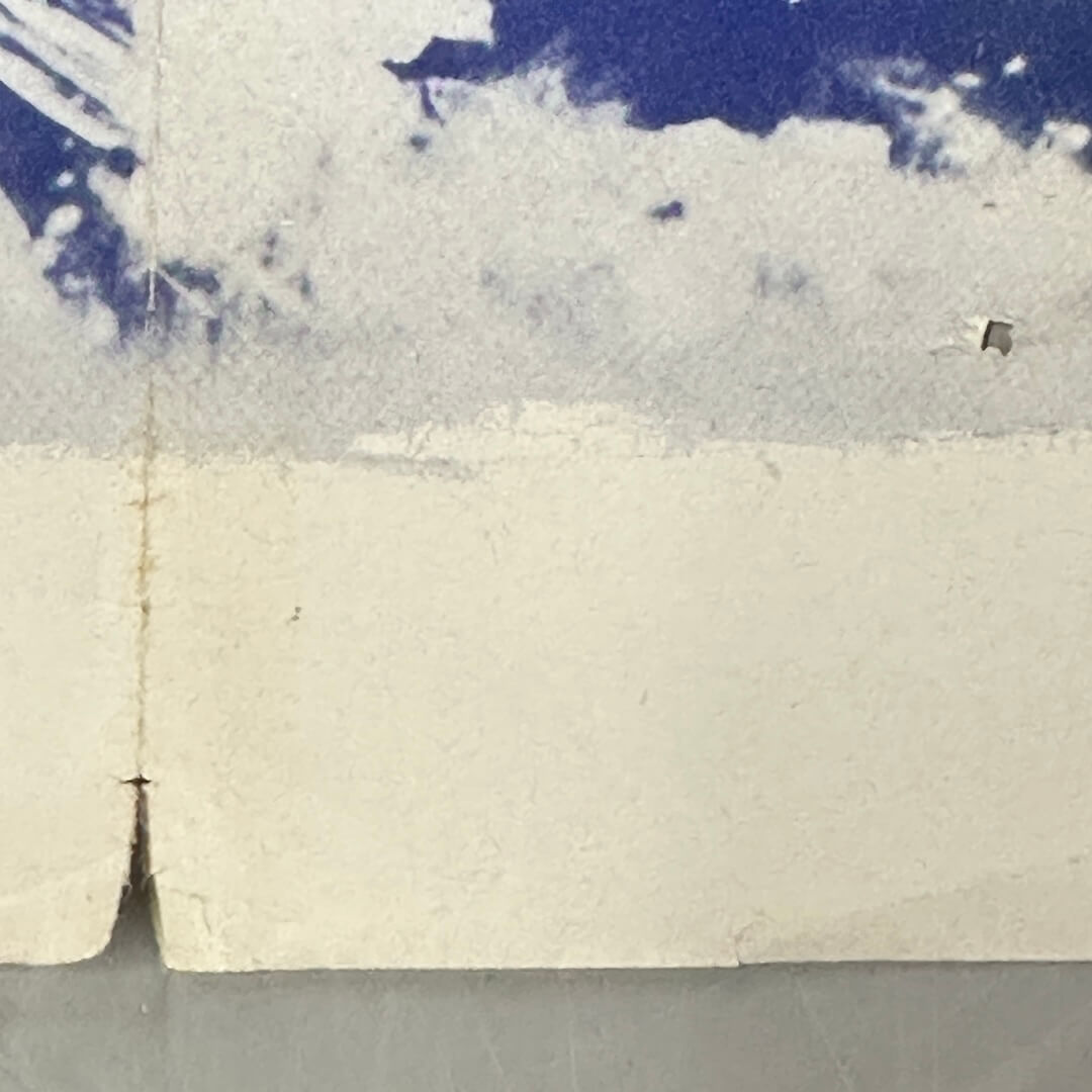 Close up of tear and hole in poster