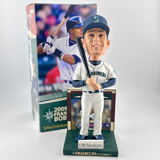 Baseball bobblehead figure with packaging featuring a player in a Mariners uniform.