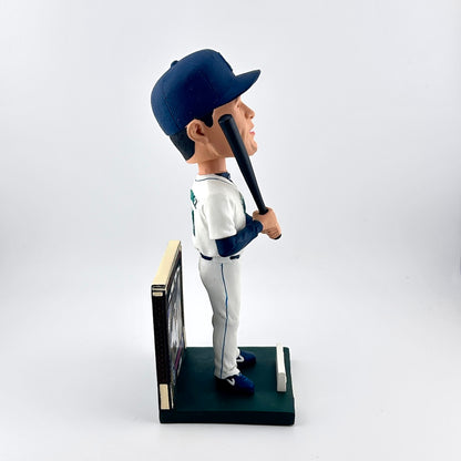 Baseball player bobblehead figure holding a bat on a white background