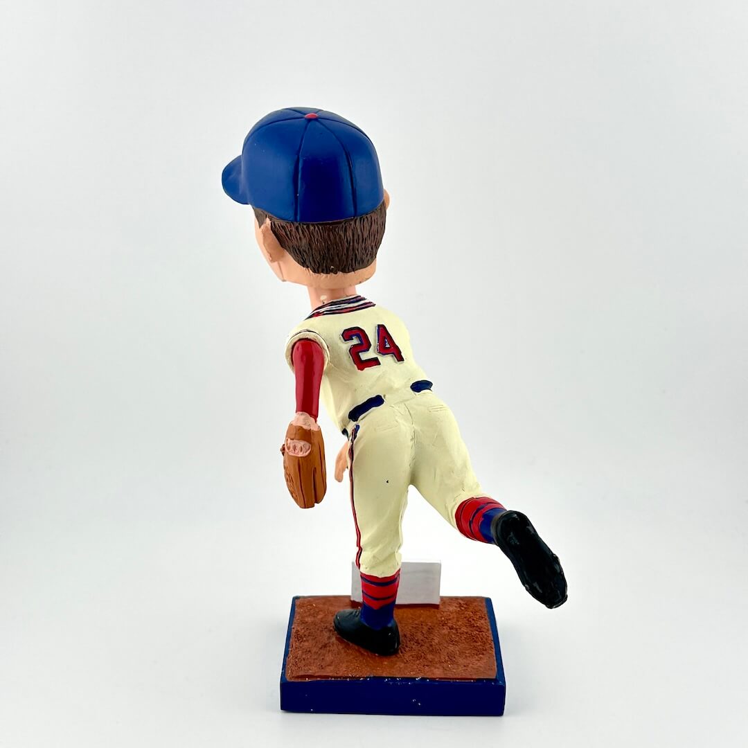 Baseball bobblehead figure with a blue cap and white uniform on a white background