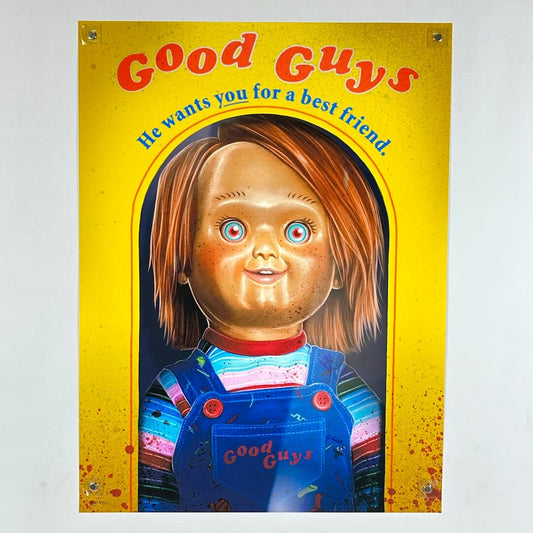 A print featuring Chucky from Child's Play with a bright yellow background with red text reading 'Good Guys'.
