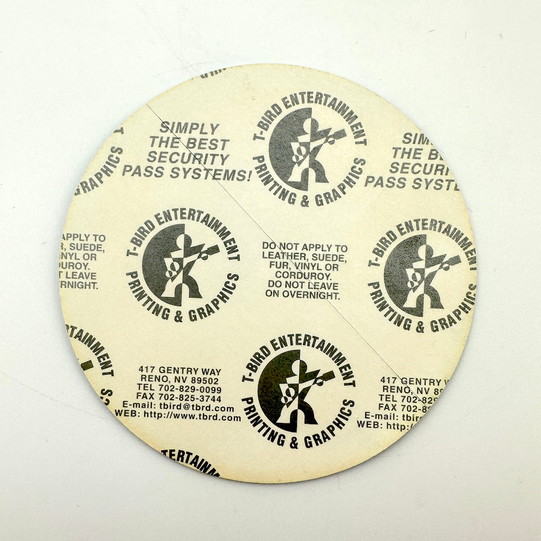 Backside of backstage pass showing intact paper backing. 