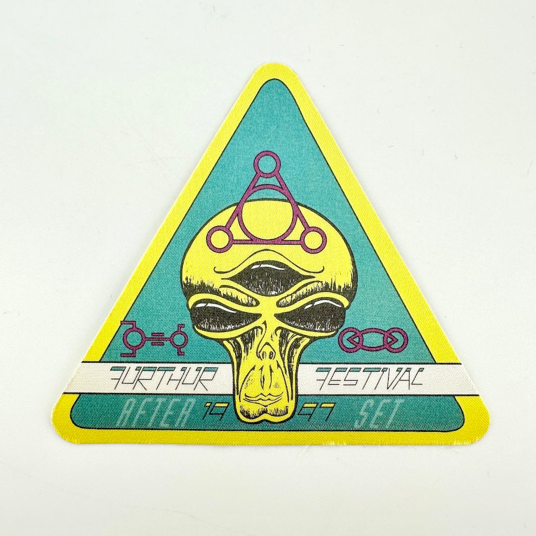 Triangular fabric backstage pass with alien face as central image and text "Furthur Festival"