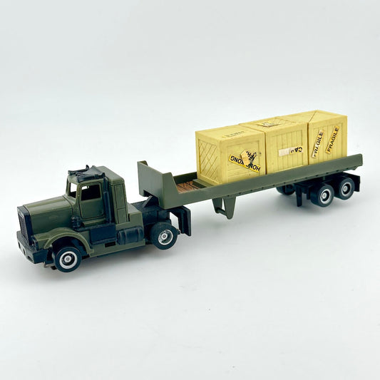 Toy truck with a flatbed carrying yellow cargo containers on a white background