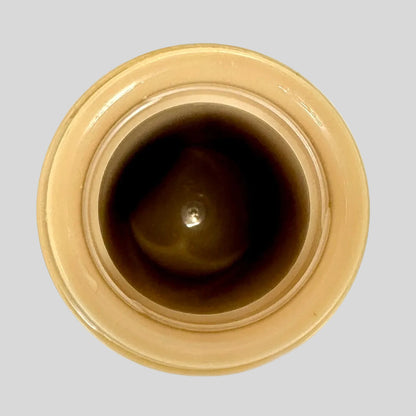 Close-up of a brown ceramic jar with a beige rim on a white background