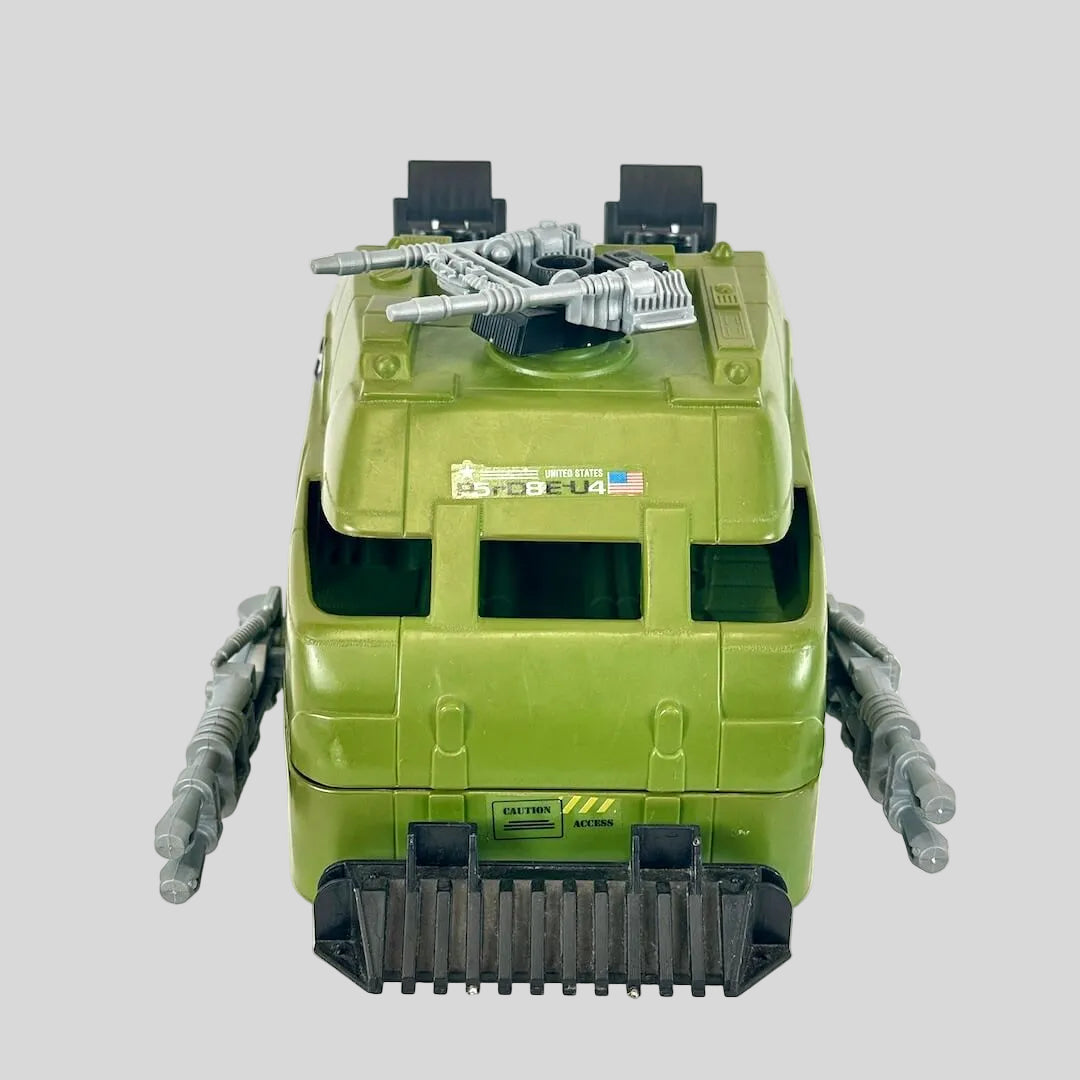 Green toy tank with America branding on gray background. 