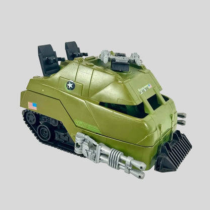 Green toy tank with gray accents on gray background.