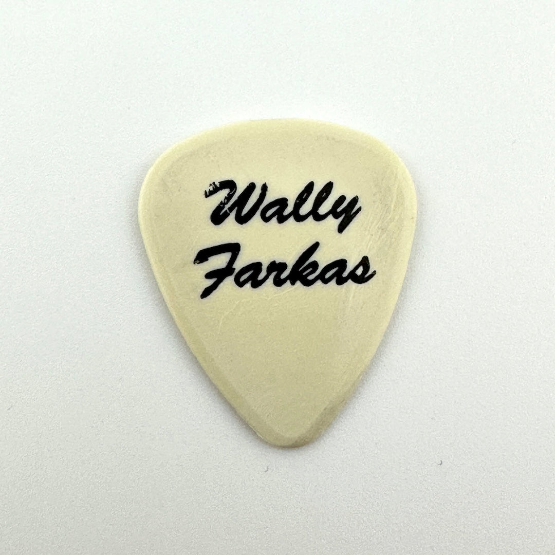 A cream-colored guitar pick with the text 'Wally Farkas' printed in black script, centered on a plain white background.