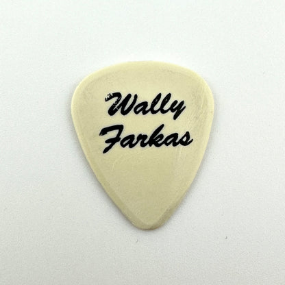 A cream-colored guitar pick with the text 'Wally Farkas' printed in black script, centered on a plain white background.