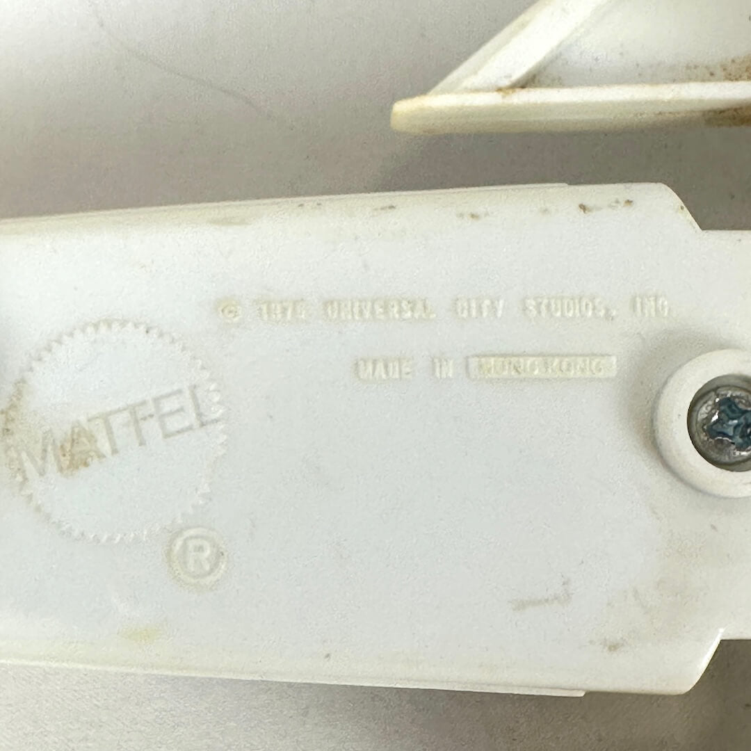 A close-up of embossed copyright and manufacturer information on bottom of craft. 