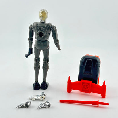 A toy silver robot standing next to a red vehicle accessory, with two silver weapon pieces and a red sword placed in front.