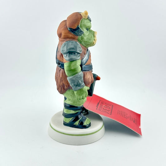 Gamorrean Guard figurine with red tag against white background. 