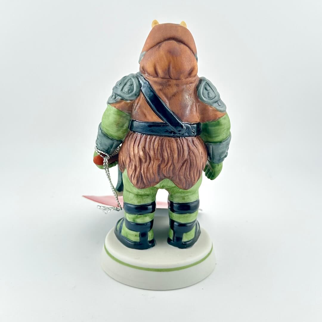 Gamorrean Guard figurine with red tag against white background. 