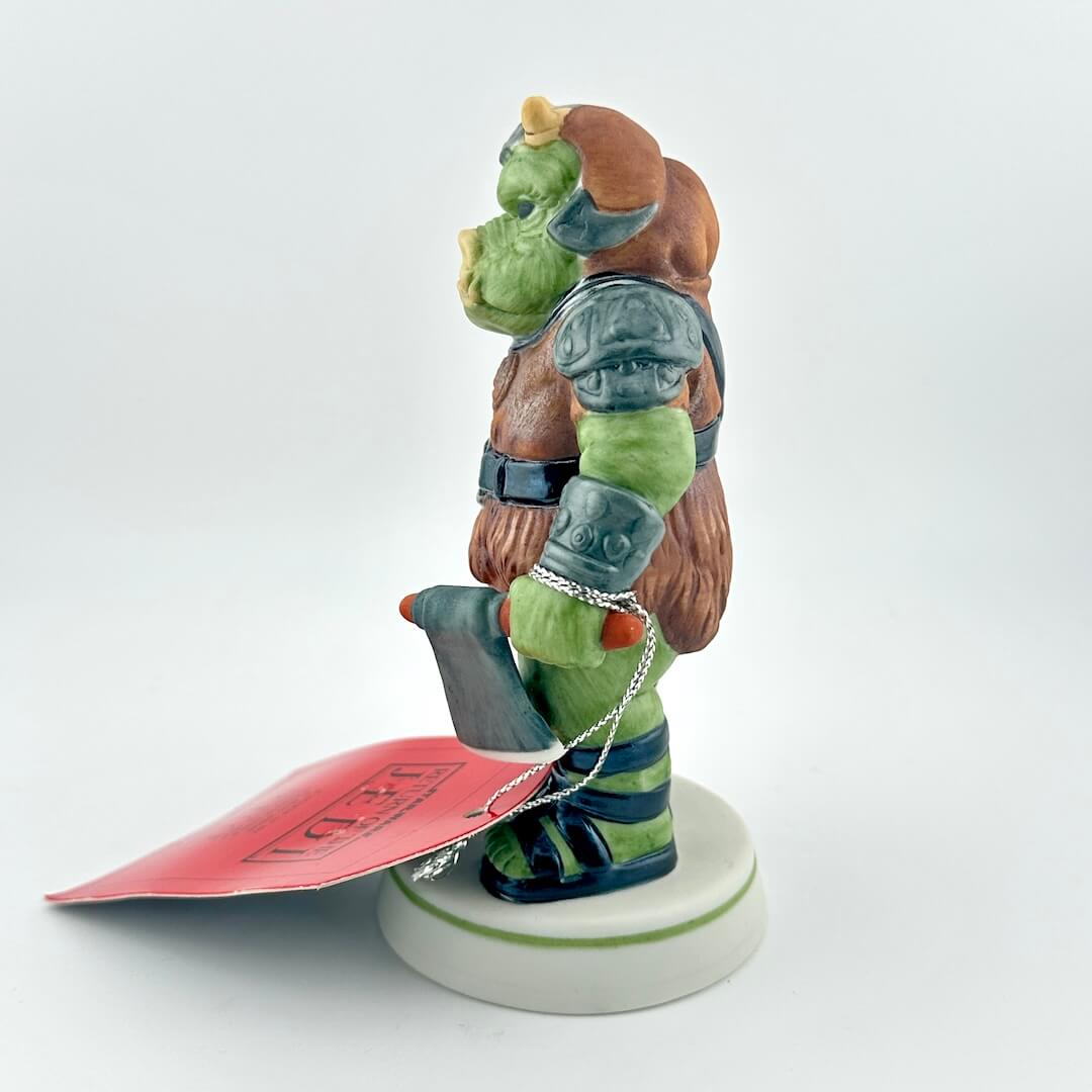 Gamorrean Guard figurine with red tag against white background. 