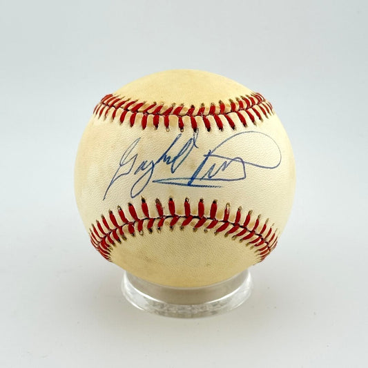 Baseball with autograph on a clear stand against a light gray background