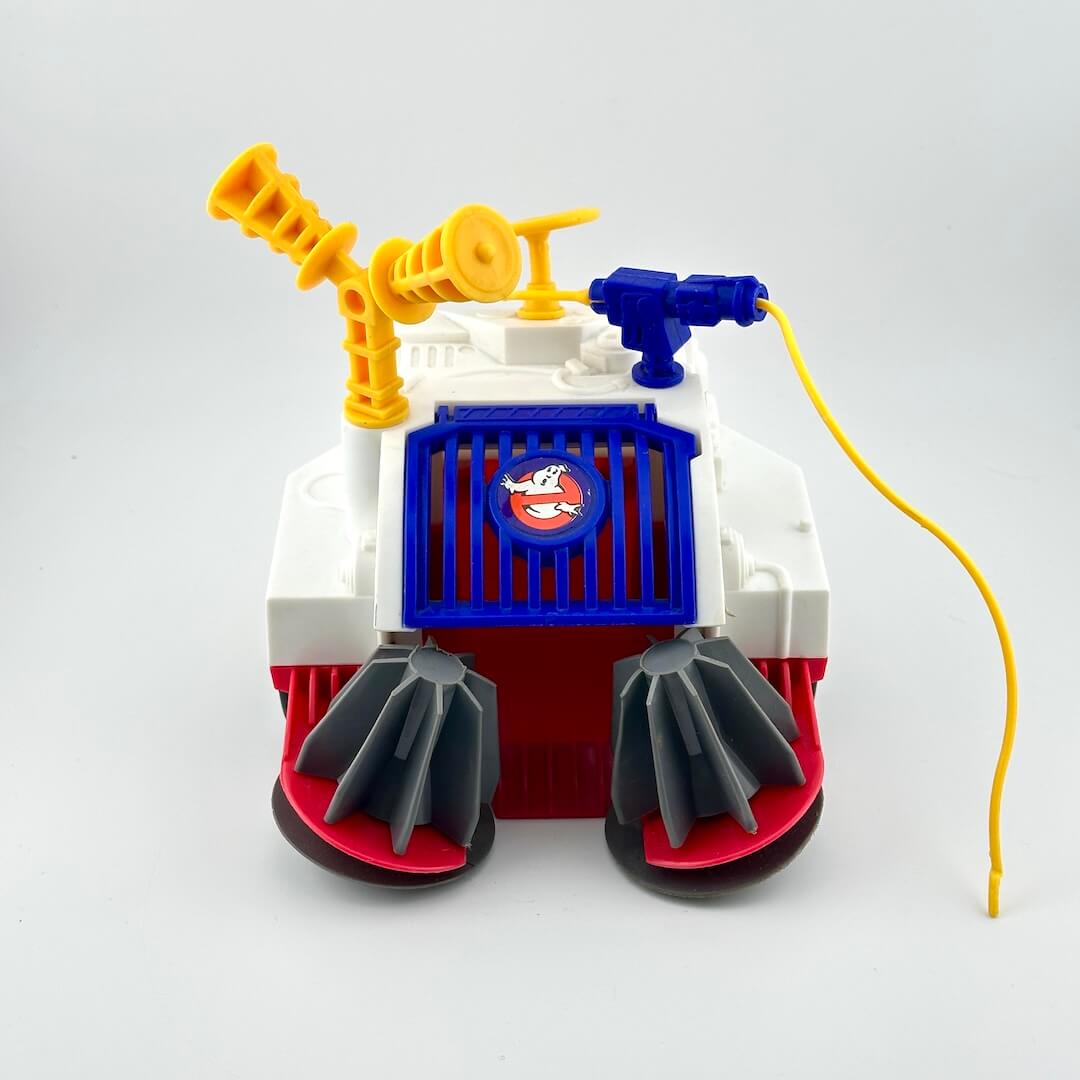 Toy robot with a red base, gray legs, and colorful top on a white background