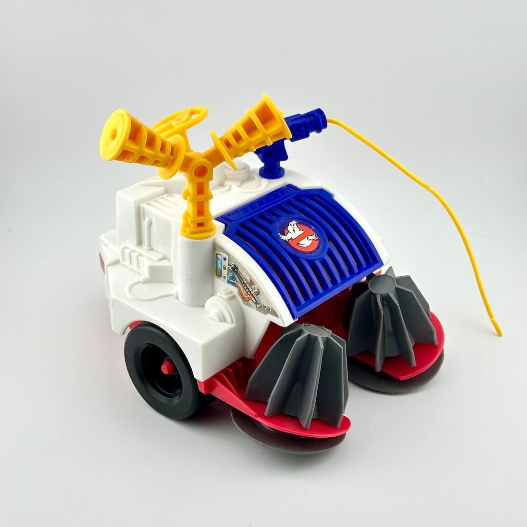 Toy vehicle with a yellow exhaust, blue top, and red and black details on a white background