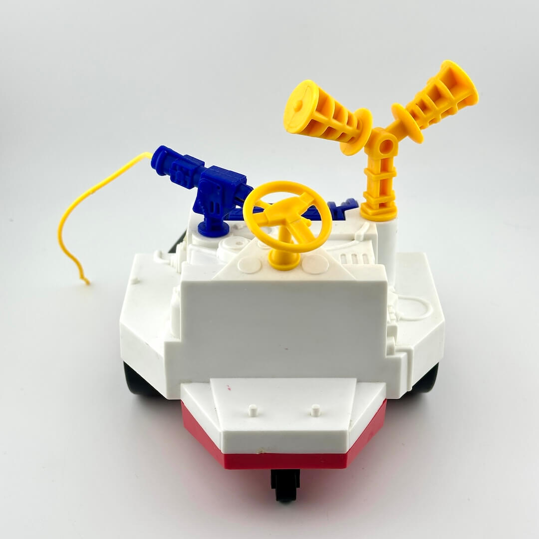 Toy vehicle with yellow and blue accents on white background. 