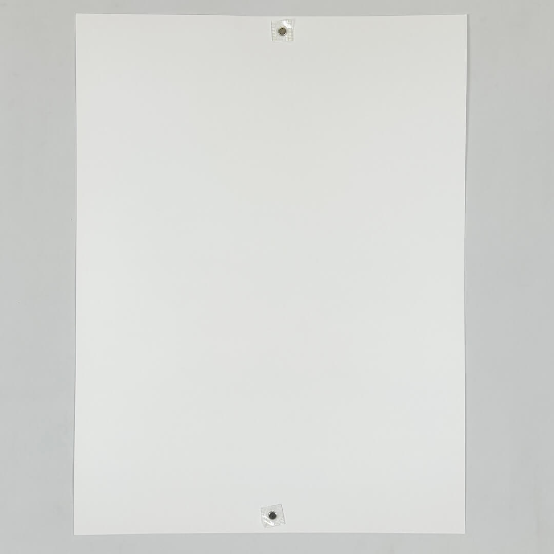 Backside of white poster against white background. 
