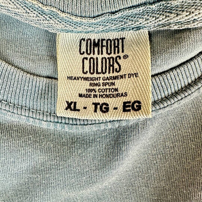Close-up of crewneck t-shirt's neck tag with 'Comfort Colors' brand and size XL. 