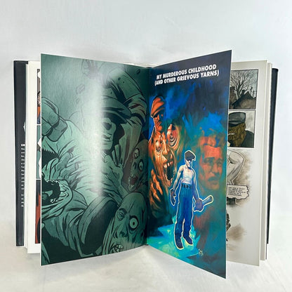An open graphic novel or art book displayed against a plain white background. 