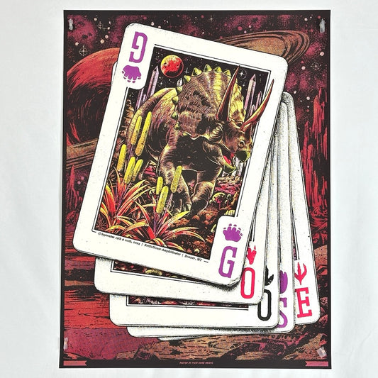 Set of white playing cards with the suit letters spelling Goose. Top card features a dinosaur. Poster has red space background. 