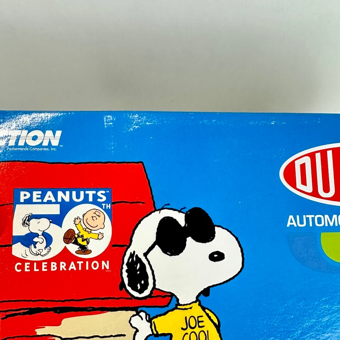 Close-up of a blue and red product box featuring Peanuts characters Snoopy and Woodstock.