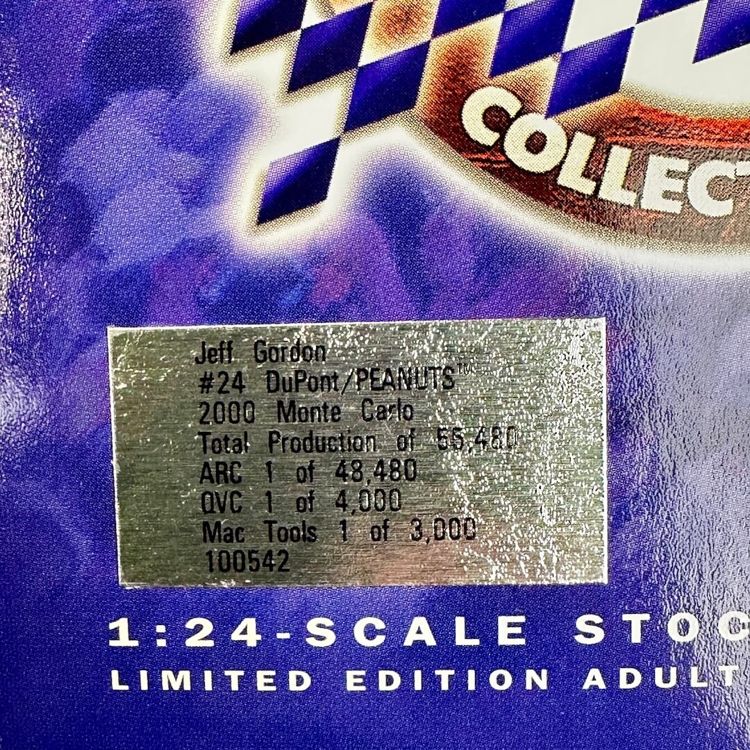Close-up of a collectible 1:24 scale model car packaging or box, featuring a silver foil label with text starting with 'Jeff Gordon'.
