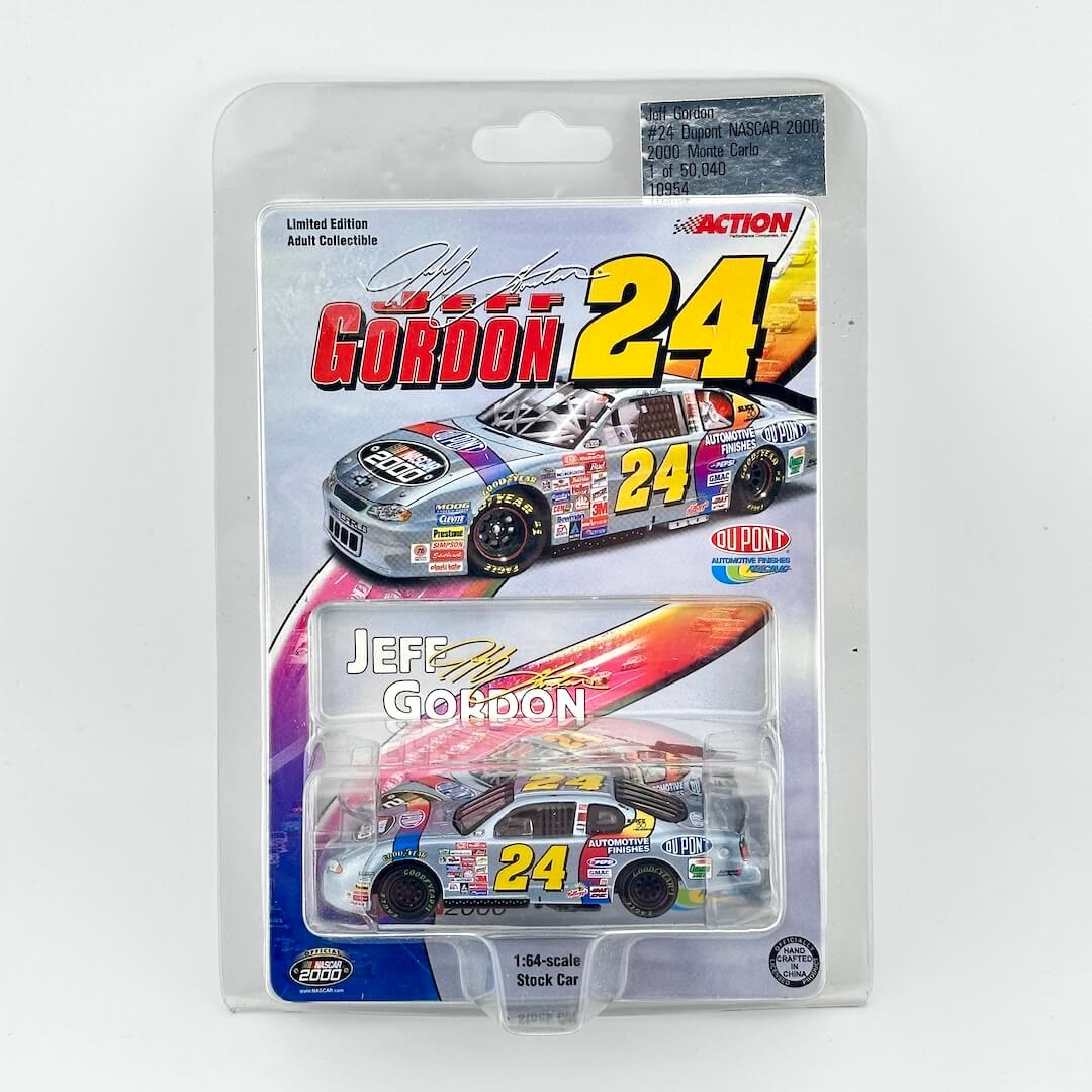 Jeff Gordon 24 diecast stock car in its original blister card packaging, featuring a silver and yellow livery with the number 24.