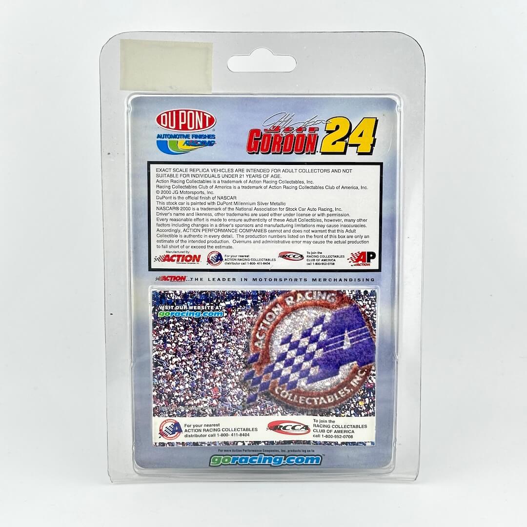Back of 1:64 scale stock car in original blister packaging, featuring product information and DuPont and Action logos.