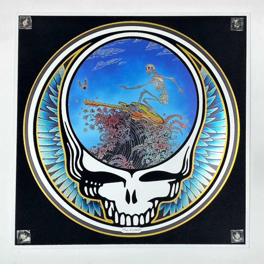 Framed Grateful Dead-themed artwork with a skull and wave design on a black background