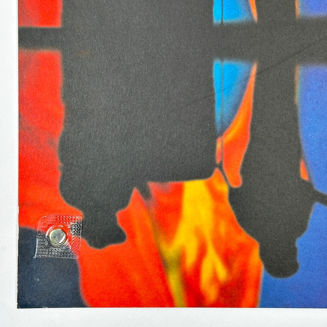 Bottom left corner of poster showing minor edge wear but sharp corner. 