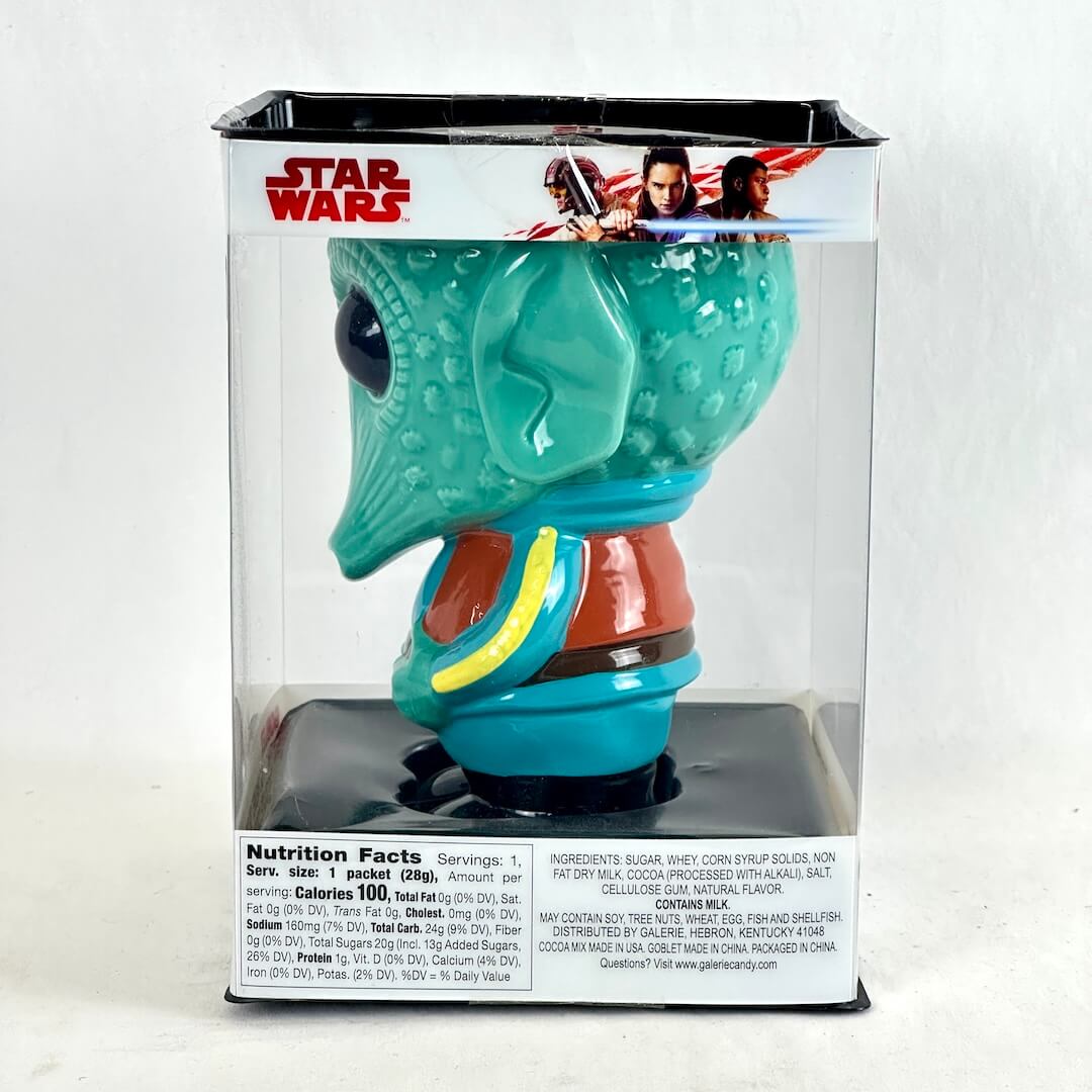 Side view of Greedo-shaped turquoise mug in clear window packaging. 