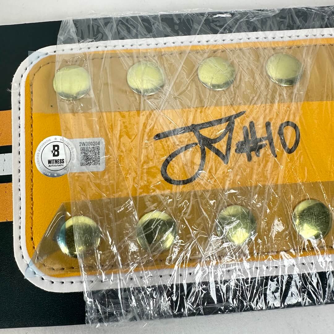 Close-up of Jordan Love signature with Beckett authentication sticker, wrapped in plastic for preservation. 
