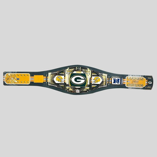 A Green Bay Packers replica championship belt displayed horizontally on a gray background. 