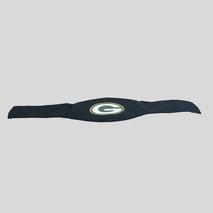 A black fabric item with a Green Bay Packers 'G' logo, laid flat on a gray background. 