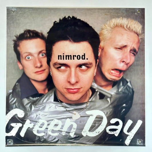 Promo poster for Green Day with band pictured at center with title across middle's forehead, and artist along bottom. 