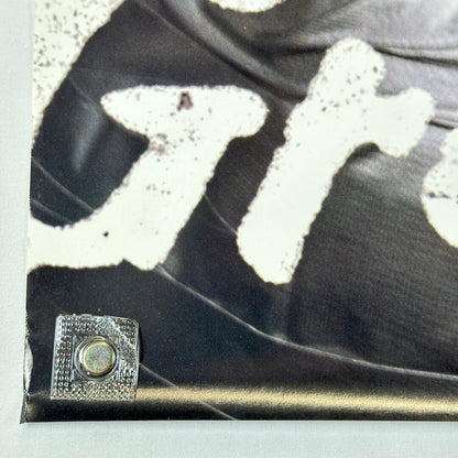 Bottom left corner of poster with slight bump to edge. 