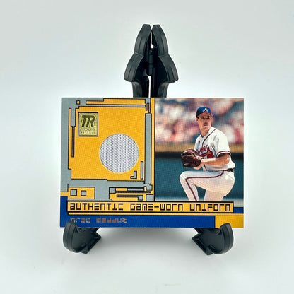 Baseball trading card with a player in a uniform and an 'Authentic Game-Worn Uniform' label on a white background.