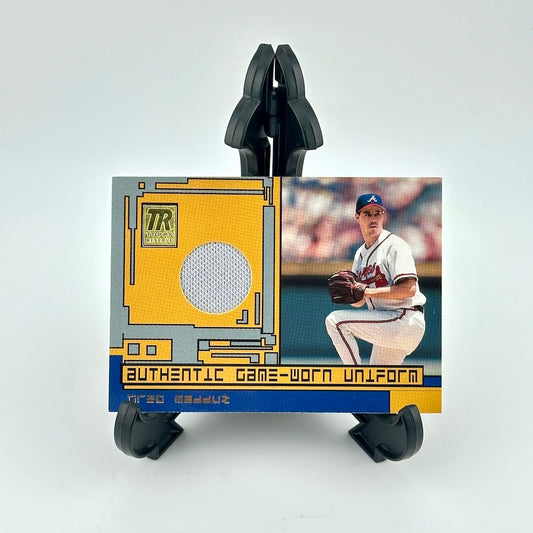 Baseball trading card with a player in a uniform and an 'Authentic Game-Worn Uniform' label on a white background.