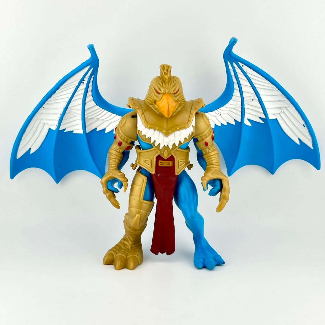 figure of winged creature with gold armor on white background. 