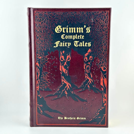 Book titled 'Grimm's Complete Fairy Tales' with decorative cover on a white background