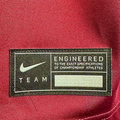 Close up of stitched hem tag on front with Nike information. 