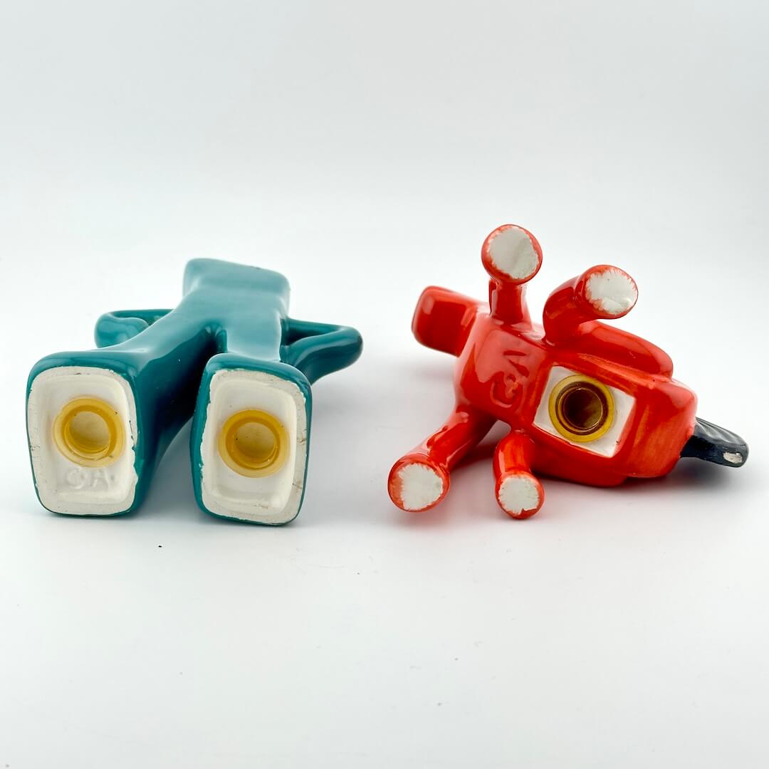 Bottoms of salt and pepper shakers to show plugs and maker's marks. 