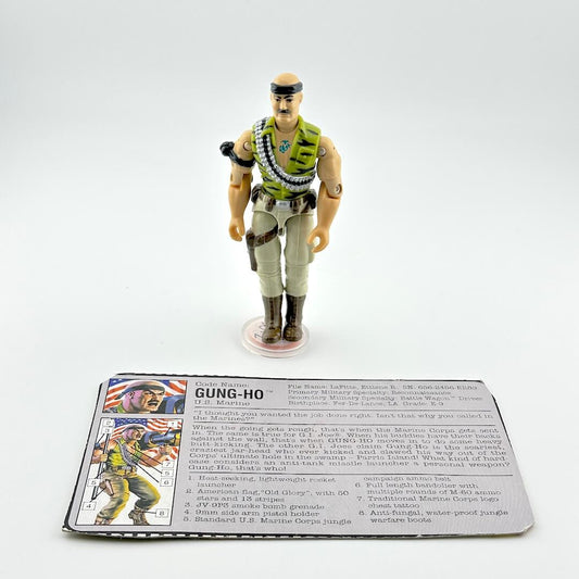 Toy figure of a character in military attire with a card below on a white background